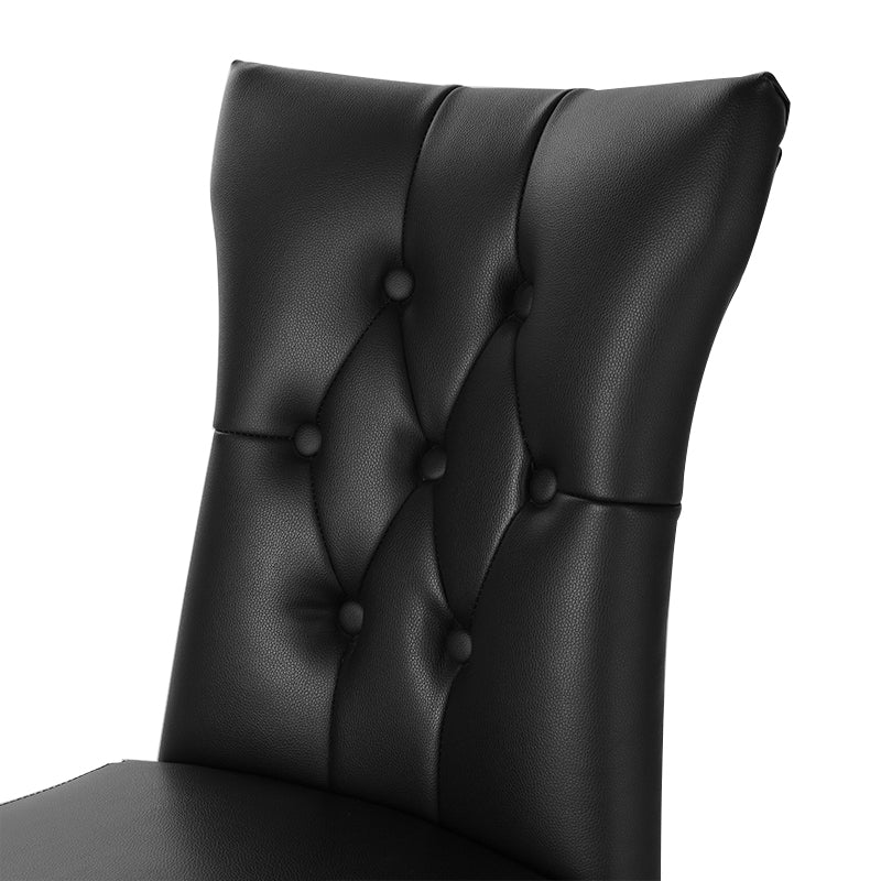 Two black PU leather dining chairs with buttons