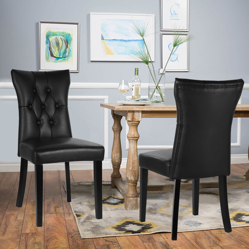 Two black PU leather dining chairs with buttons